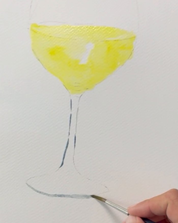 Traits gris-bleutés peints au pinceau sur le pied d'un verre à l'aquarelle